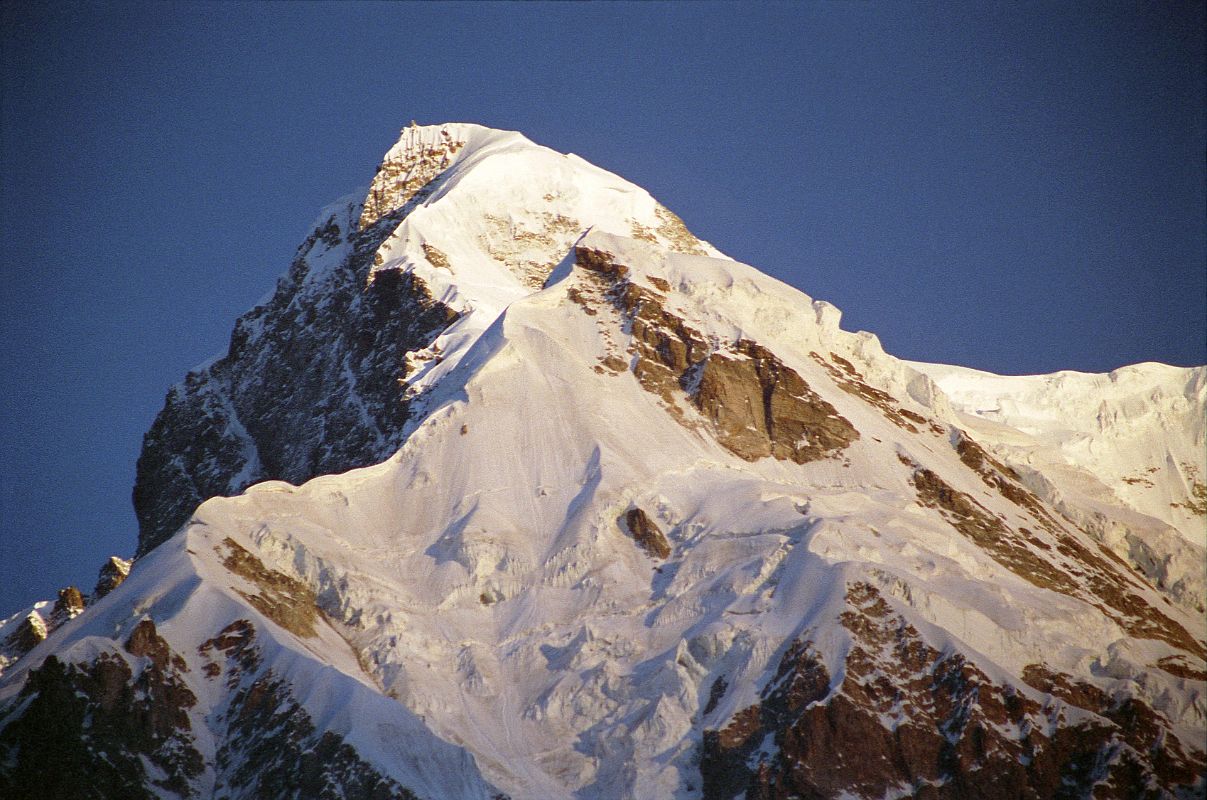 10 Rakhiot Peak East Face Close Up From Tarashing At Sunrise Rakhiot Peak South Face to the left and East Face to the right shine in the early morning sun from Tarashing. Rakhiot Peak (7070m) was first climbed on July 16, 1932 by Peter Aschenbrenner and Herbert Kunigk while attempting Nanga Parbat. Hermann Buhl climbed the summit needle of Rakhiot Peak on June 21, 1953 on the way to the first ascent of Nanga Parbat.